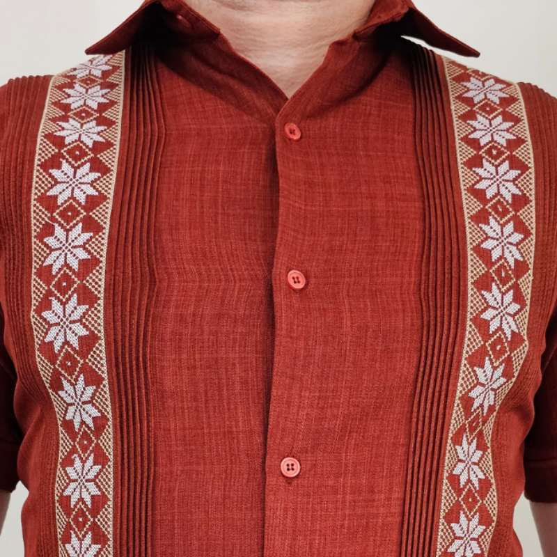 Detalle de los bolsillos y alforzas de la guayabera terracota.