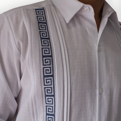 Modelo luciendo guayabera blanca bordado azul en evento formal