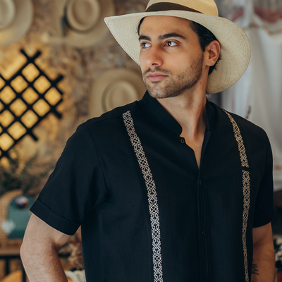 Modelo usando guayabera negra bordada manga corta