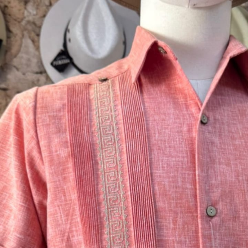 Modelo usando guayabera rosa bordada manga corta